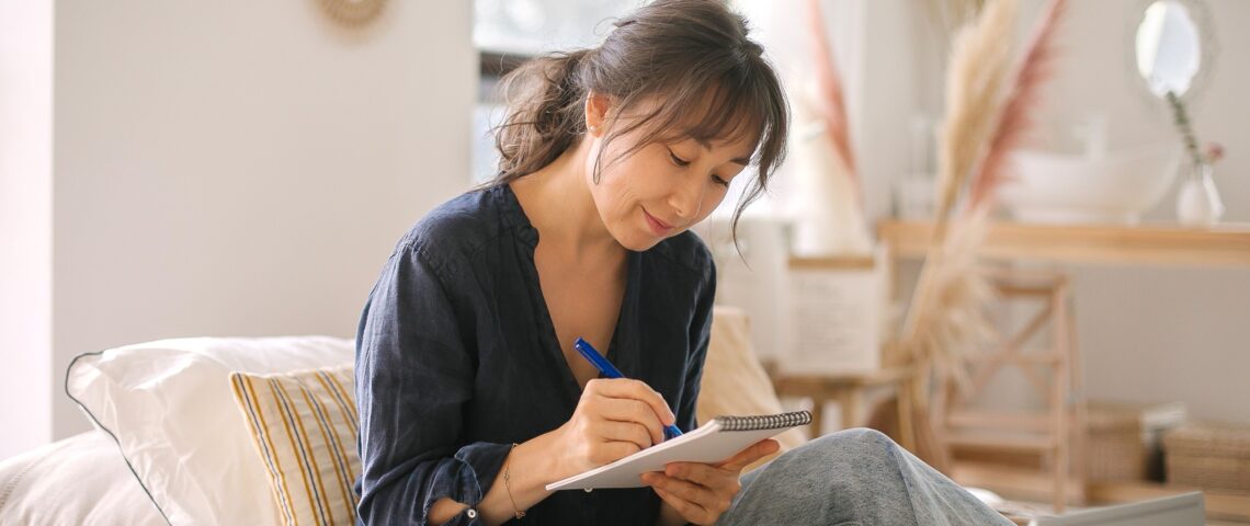 Focused woman making notes in a notebook