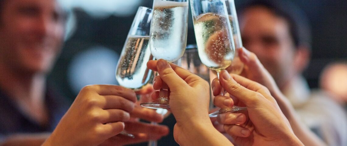 Friends making a toast, clinking glasses of champagne