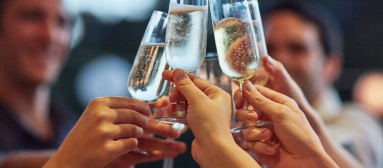 Friends making a toast, clinking glasses of champagne