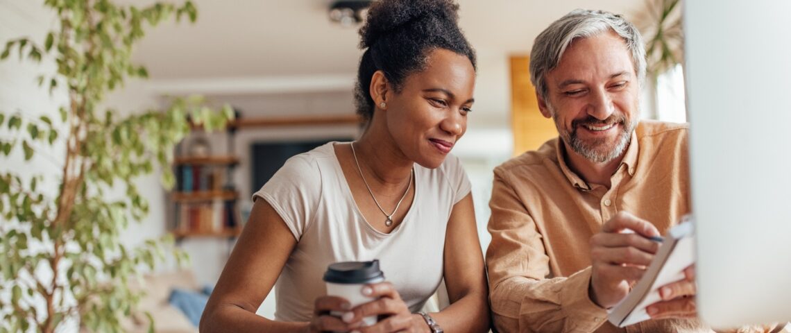 Couple smiles as they look at a list