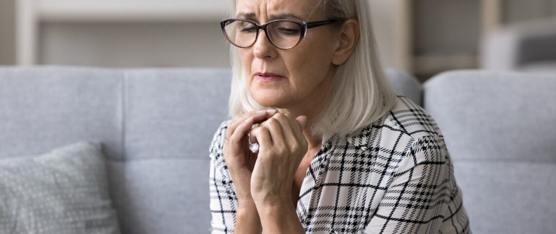 An older woman looking anxious
