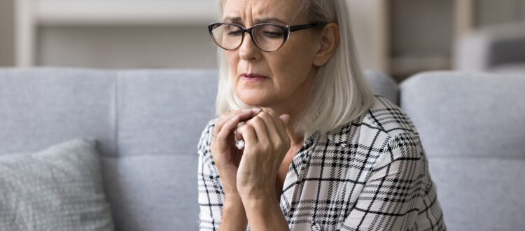 An older woman looking anxious