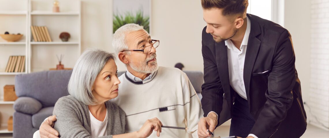 senior couple engaged in discussions with professional man