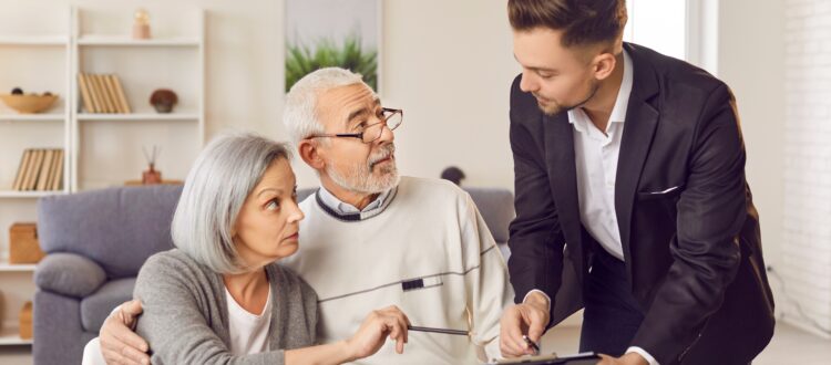 senior couple engaged in discussions with professional man