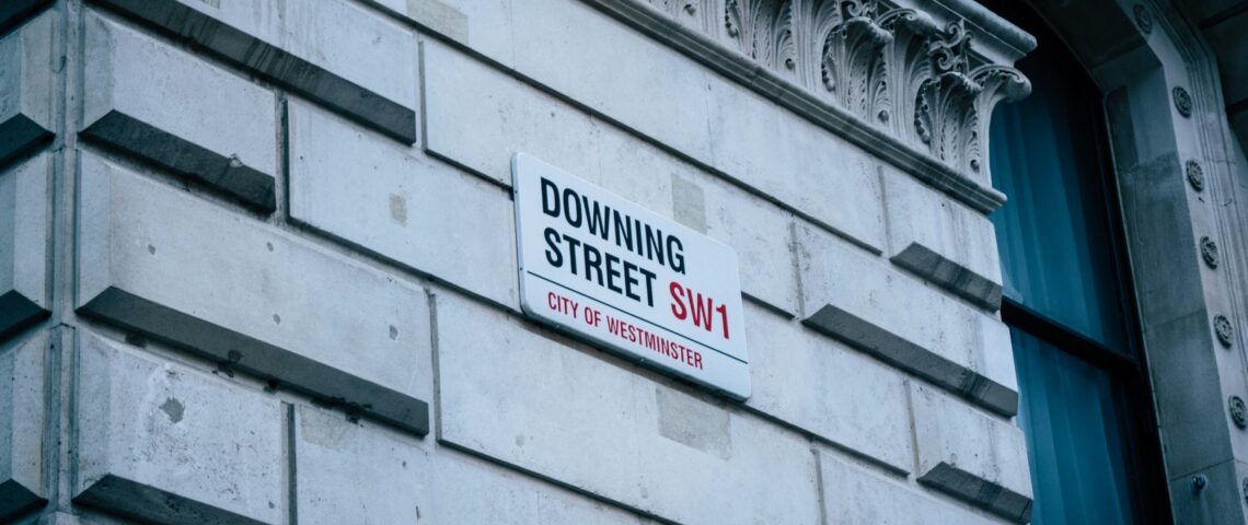 road sign of Downing Street on the side of a building in London